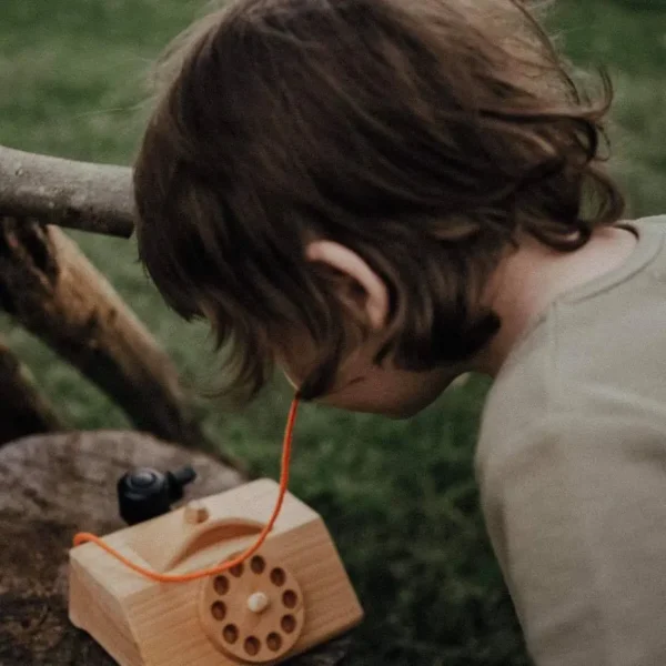 kid playing Wooden Telephone
