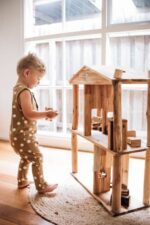 kid playing with Doll House