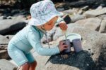 kid playing with sand bucket