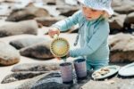 kid playing with sand bucket