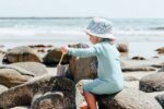 kid playing with sand bucket