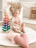 Girl playing with colorful Marble Tree