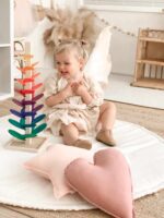 Girl playing with Rainbow Marble Tree