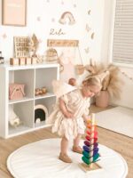 Girl playing with Rainbow Marble Tree