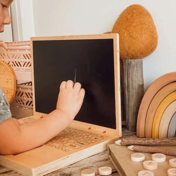 child playing with Wooden Play Laptop