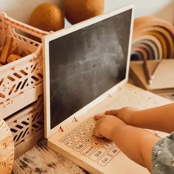 child playing with Wooden Play Laptop