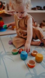 child playing with bowls