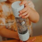 kid playing with bottle