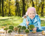 girl playing with Wooden Trees