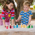 children playing with Dolls by Freckled Frog