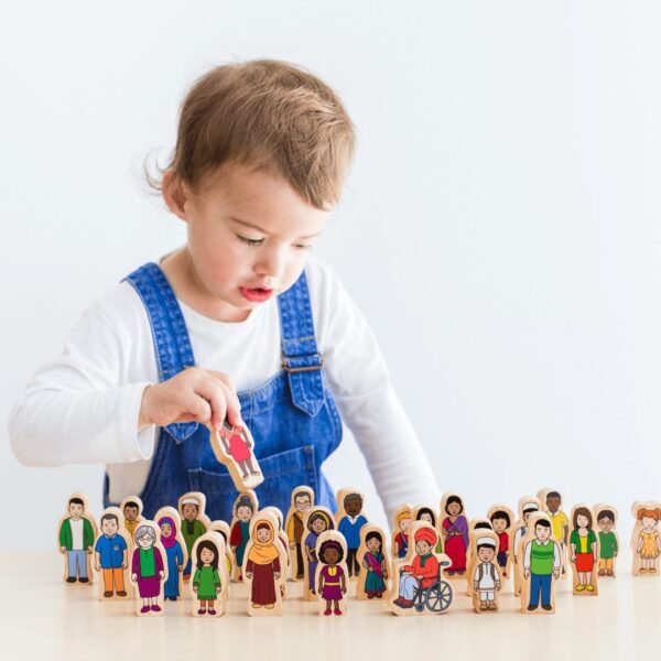 kid playing with wooden family set