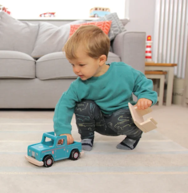 Boy playing with Mini Tess SUV